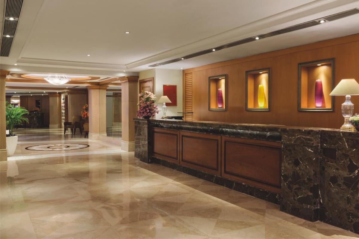 a lobby with a reception desk in a hotel at Ramada Plaza By Wyndham Palm Grove in Mumbai
