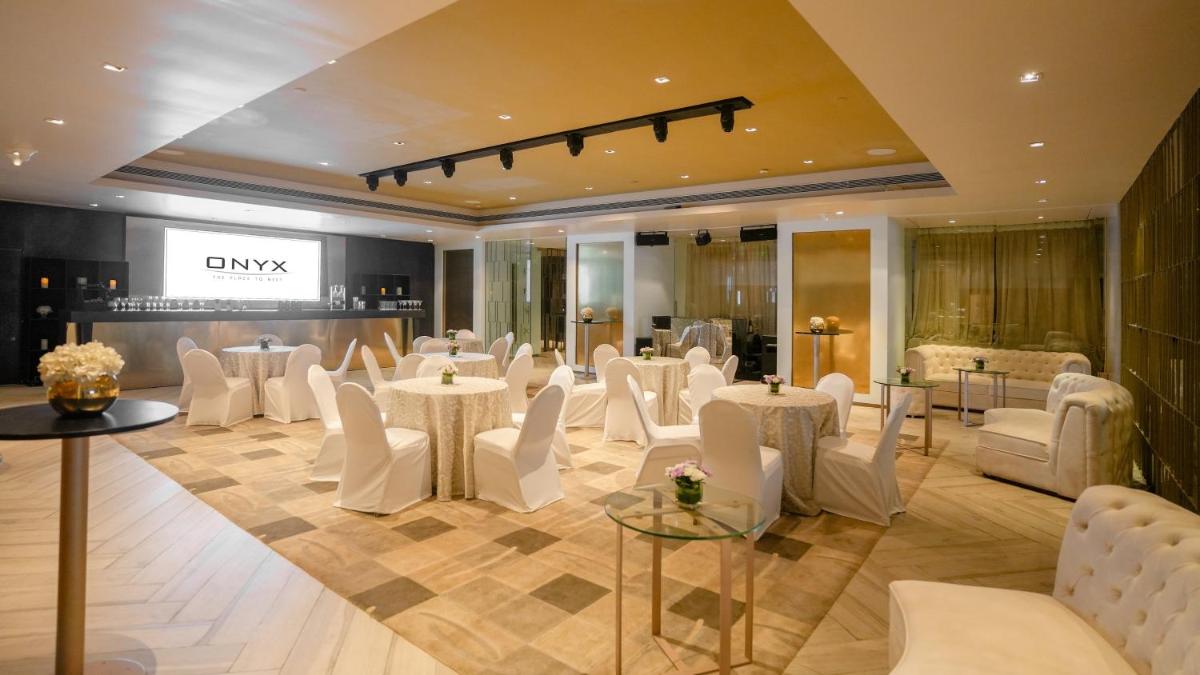 a banquet hall with white chairs and tables at InterContinental Marine Drive Mumbai by IHG in Mumbai