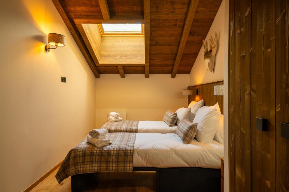 Un ou plusieurs lits dans un hébergement de l'établissement Résidence l'Ecrin d'Argent by My Mountain Resort