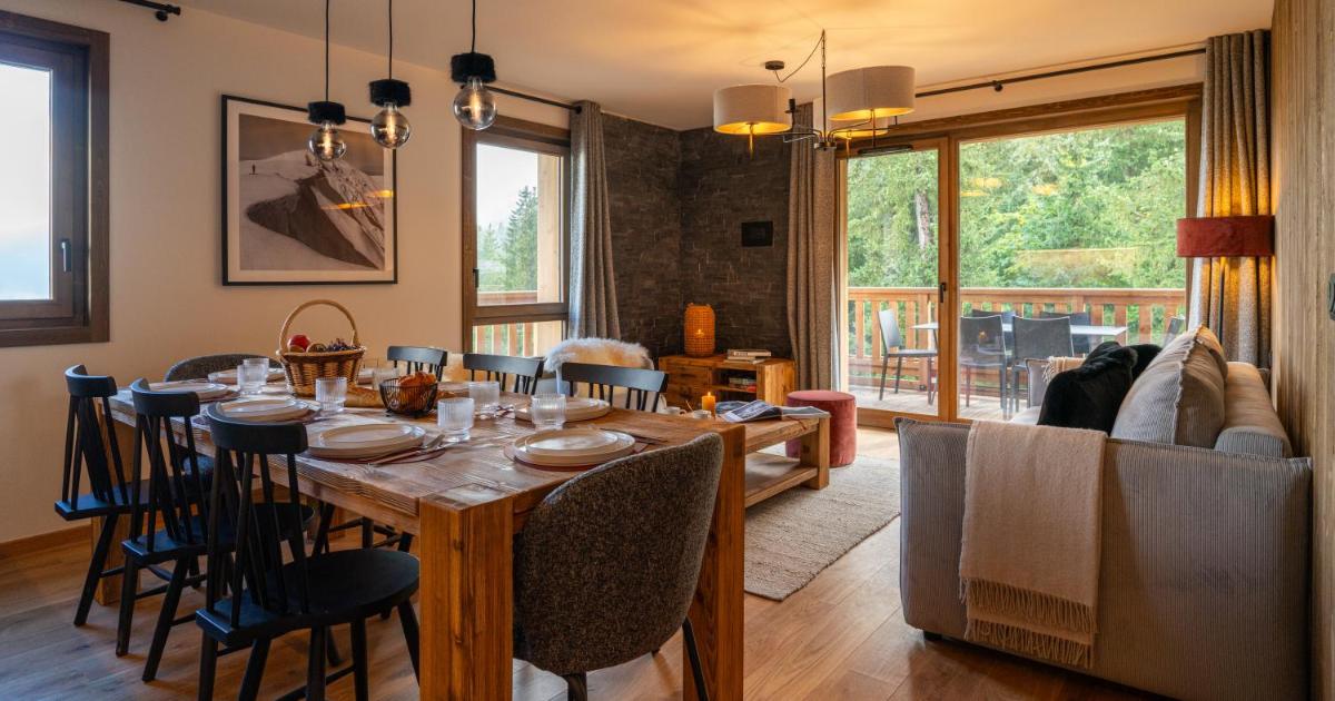 une salle à manger avec une table et des chaises en bois dans l'établissement Résidence l'Ecrin d'Argent by My Mountain Resort, à Valmorel