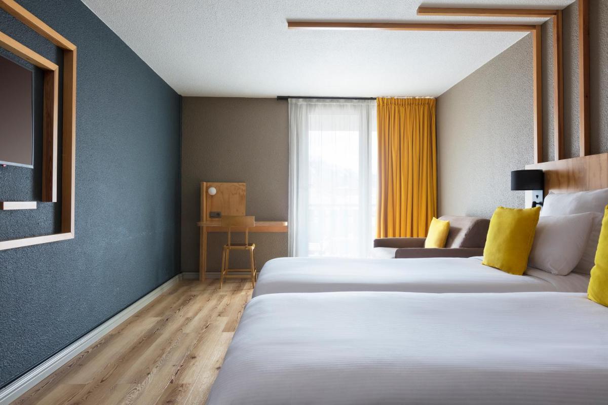 Un ou plusieurs lits dans un hébergement de l'établissement Hôtel Les Aiglons Chamonix