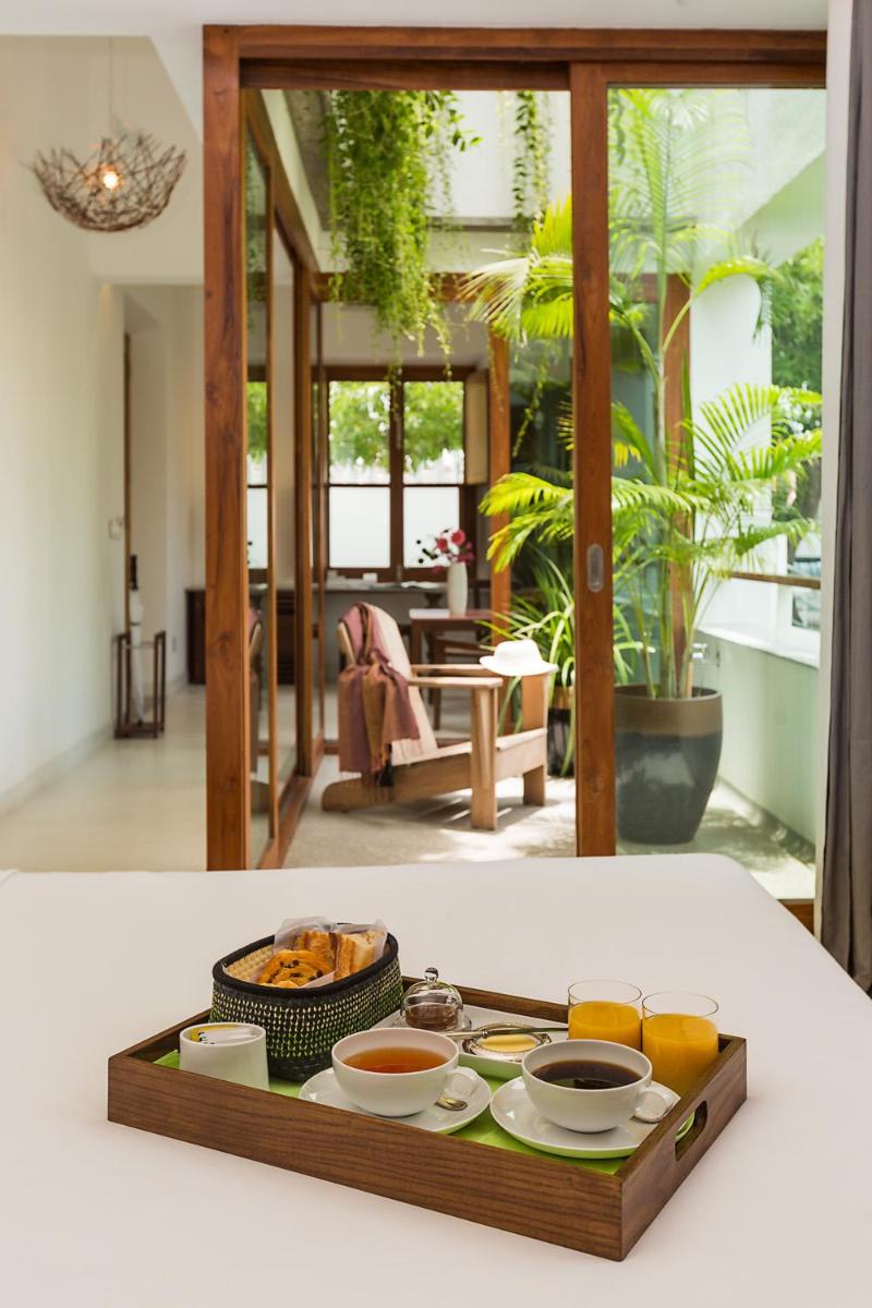 a tray with bowls of food on a table at La Villa in Puducherry
