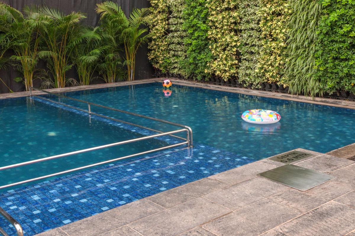 a swimming pool with a toy in the water at Hyatt Centric Candolim Goa in Calangute a swimming pool with a toy in the water at Hyatt Centric Candolim Goa in Calangute