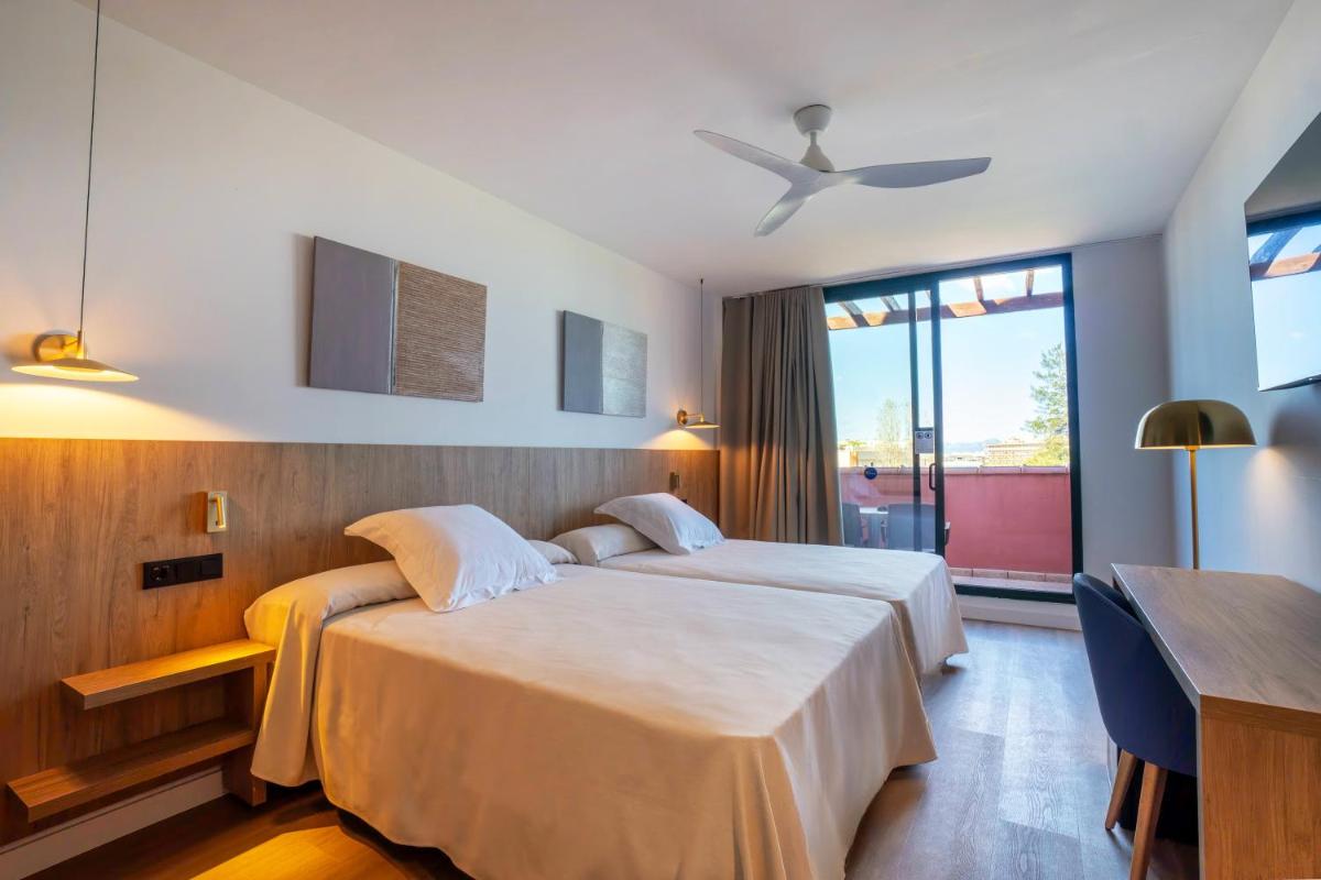 Cama o camas de una habitación en Ohtels Vil·la Romana