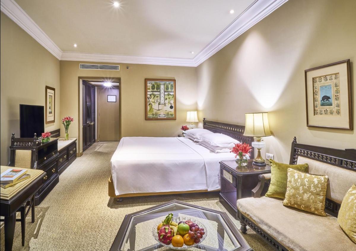 a large hotel room with a bed and a couch at Taj Bengal in Kolkata