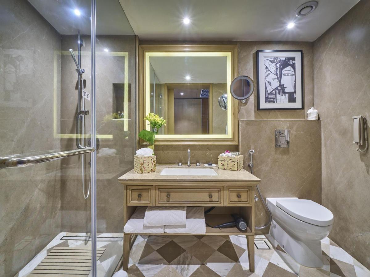 a bathroom with a sink and a toilet and a shower at Taj Bengal in Kolkata