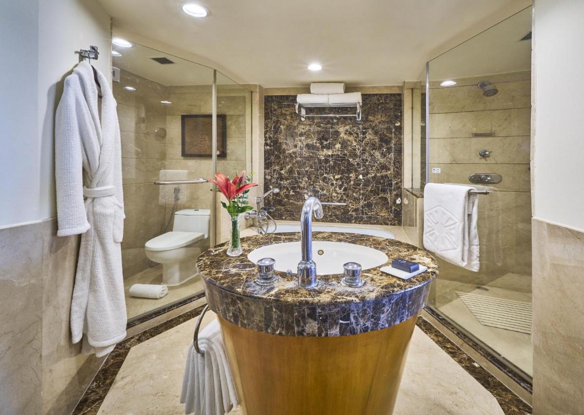 a bathroom with a sink and a toilet at Taj Bengal in Kolkata
