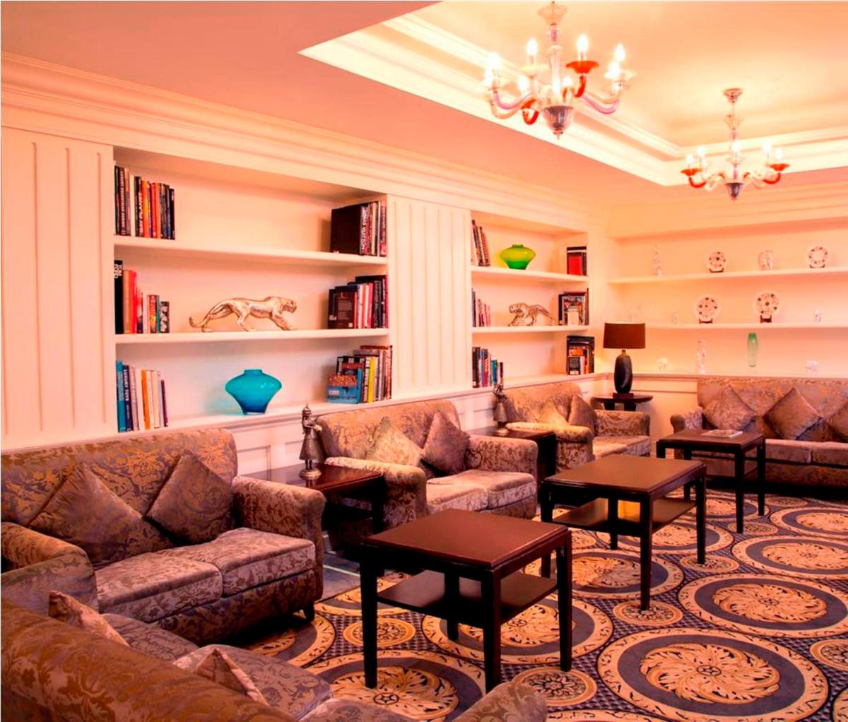 a living room with couches and bookshelves at Radisson Blu Kochi in Cochin