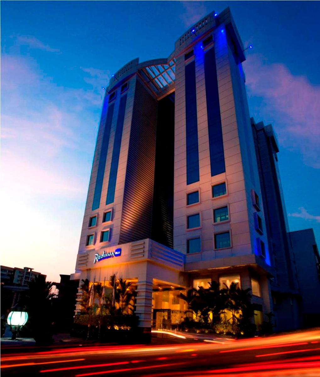 a large building with a blue light on it at Radisson Blu Kochi in Cochin