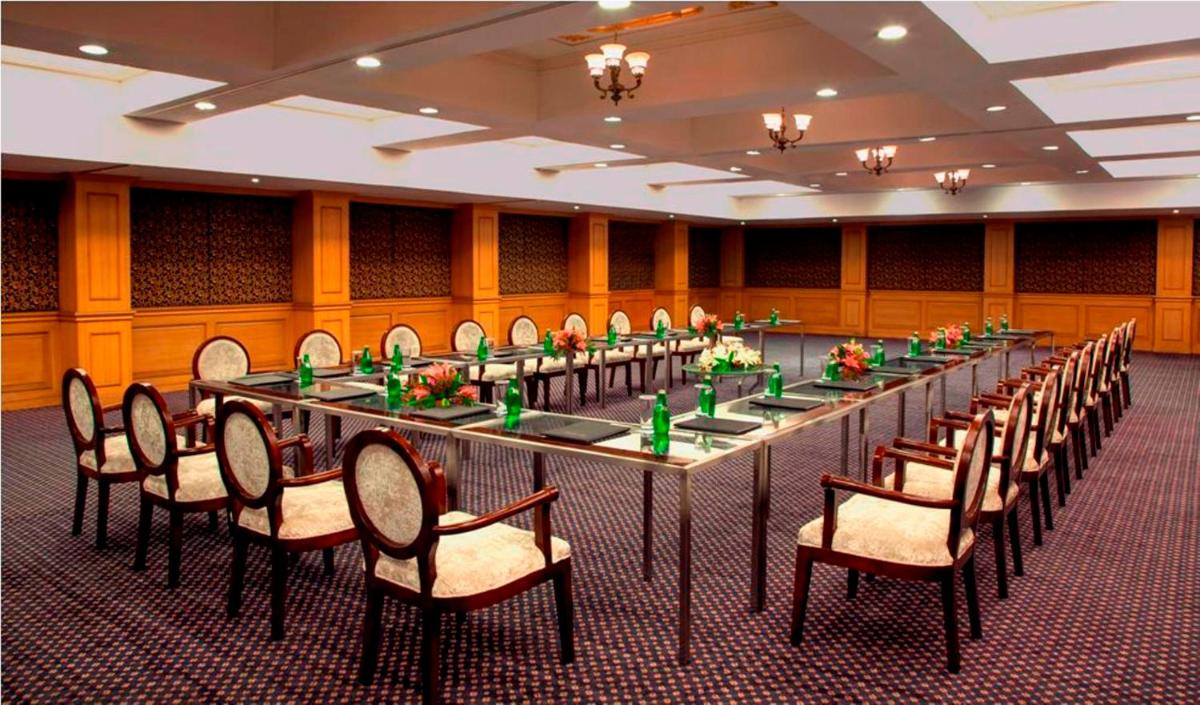 a conference room with a long table and chairs at Radisson Blu Kochi in Cochin