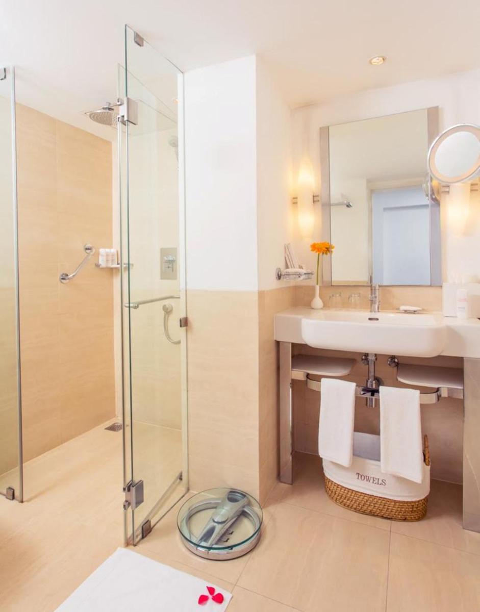a bathroom with a sink and a shower at Radisson Blu Kochi in Cochin