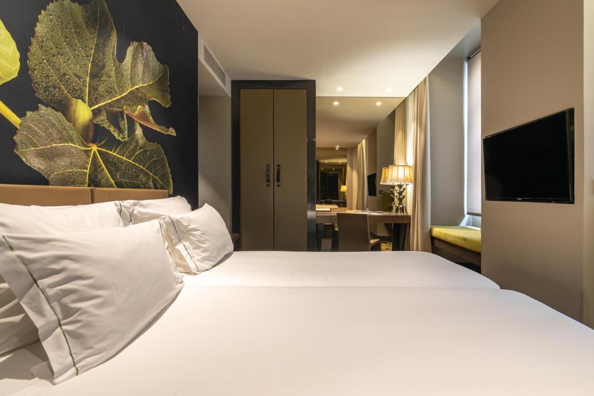 Uma cama ou camas num quarto em Figueira by The Beautique Hotels & Spa