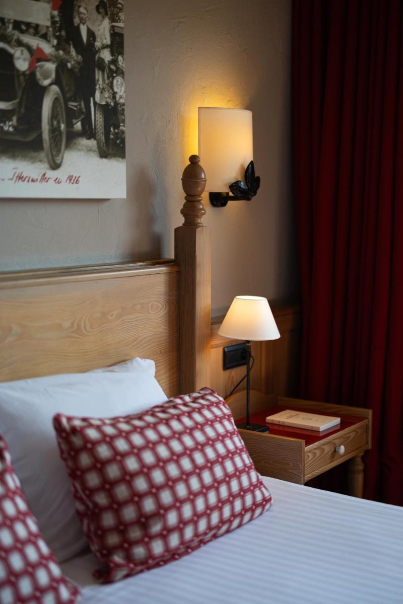 Un ou plusieurs lits dans un hébergement de l'établissement Hôtel Arnold