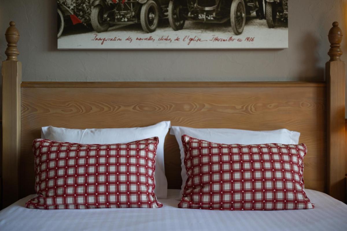 Un ou plusieurs lits dans un hébergement de l'établissement Hôtel Arnold