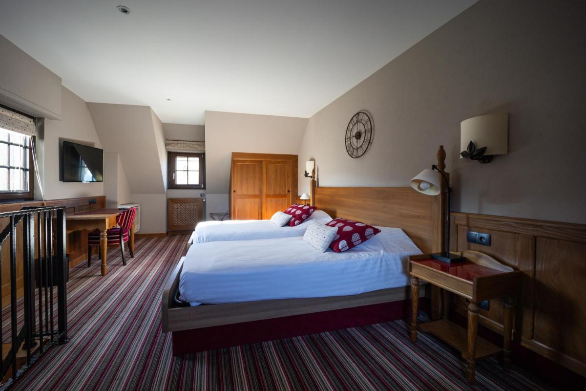 Un ou plusieurs lits dans un hébergement de l'établissement Hôtel Arnold