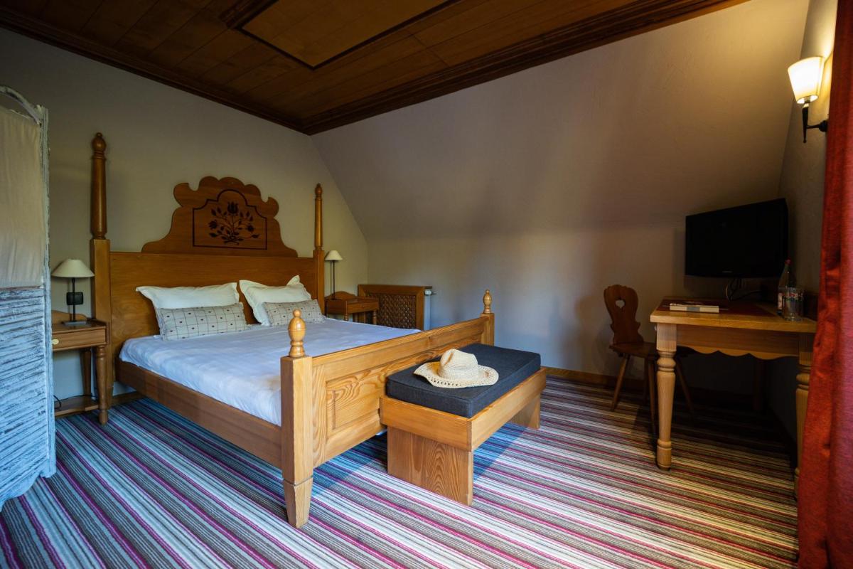 Un ou plusieurs lits dans un hébergement de l'établissement Hôtel Arnold