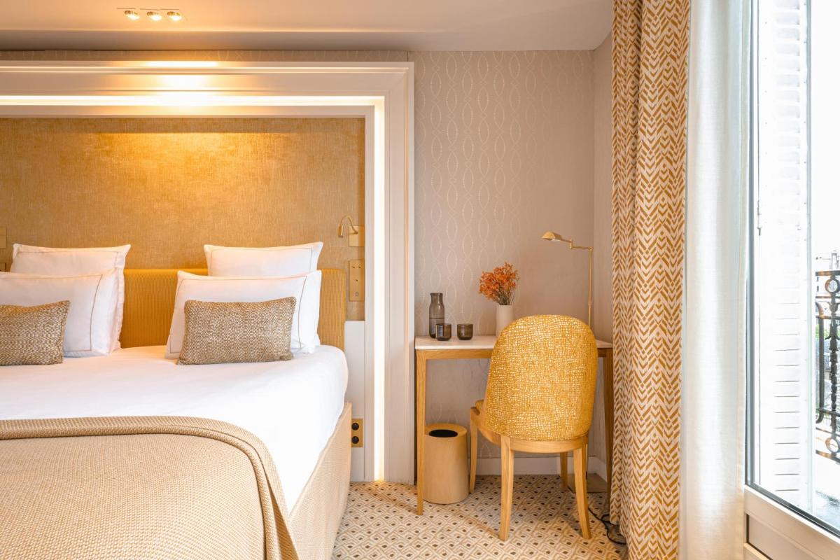 Un ou plusieurs lits dans un hébergement de l'établissement Hôtel Madison