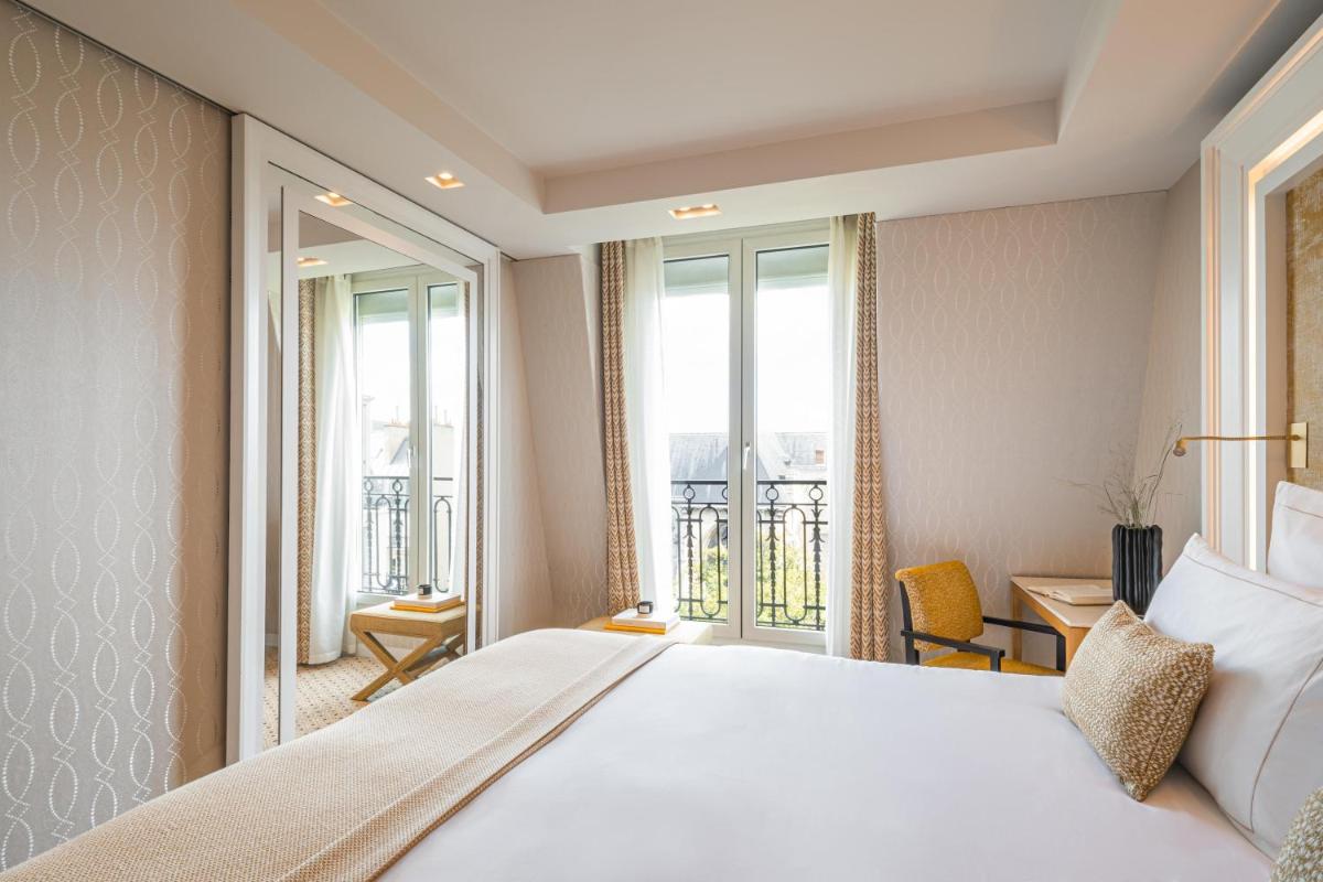 Un ou plusieurs lits dans un hébergement de l'établissement Hôtel Madison