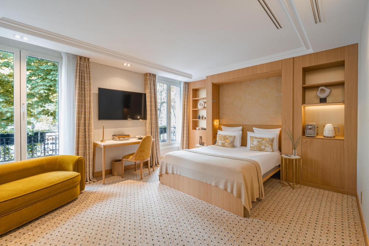 Un ou plusieurs lits dans un hébergement de l'établissement Hôtel Madison