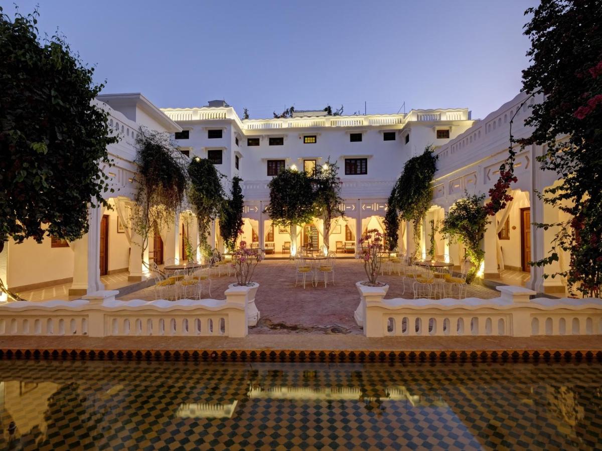 a large building with a courtyard with a pool at Saraca Hotel Lucknow in Lucknow