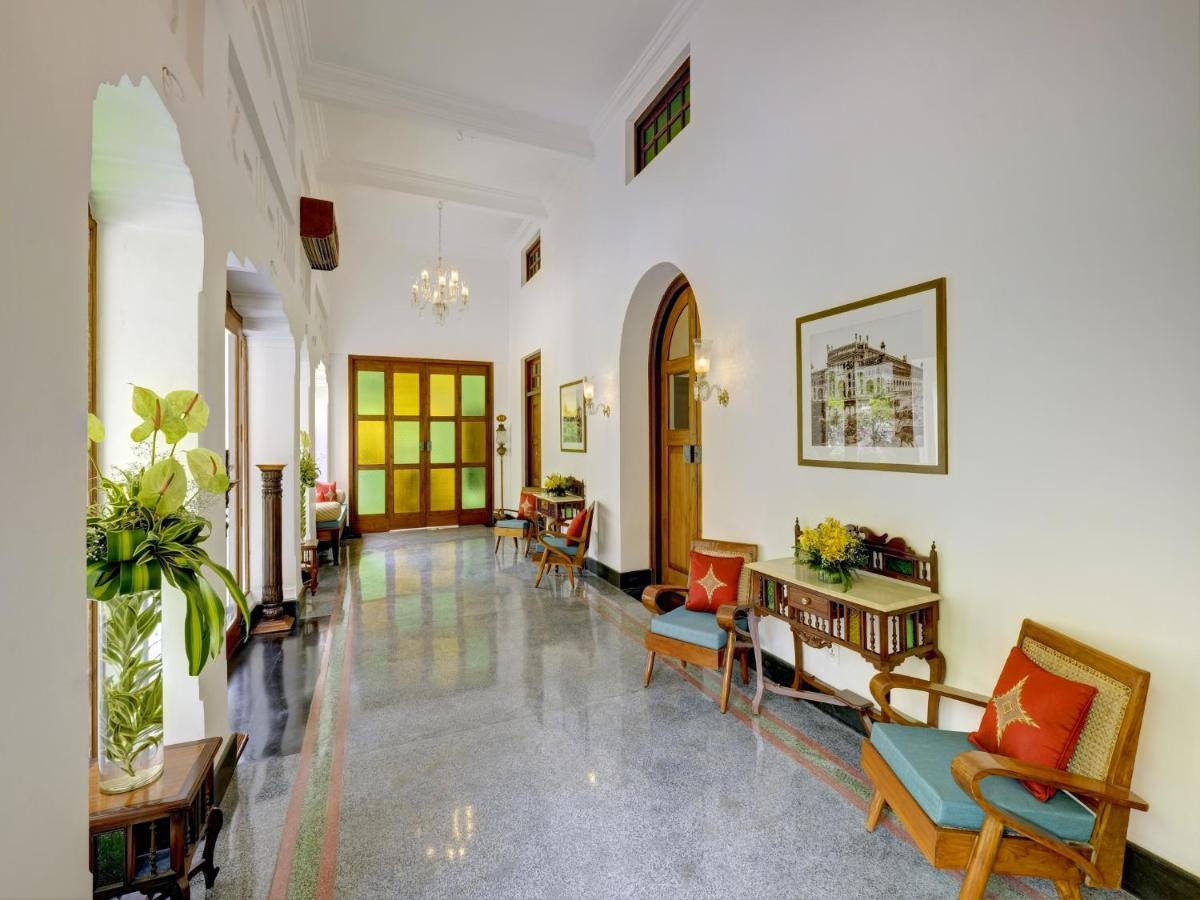 a hallway with chairs and tables in a building at Saraca Hotel Lucknow in Lucknow