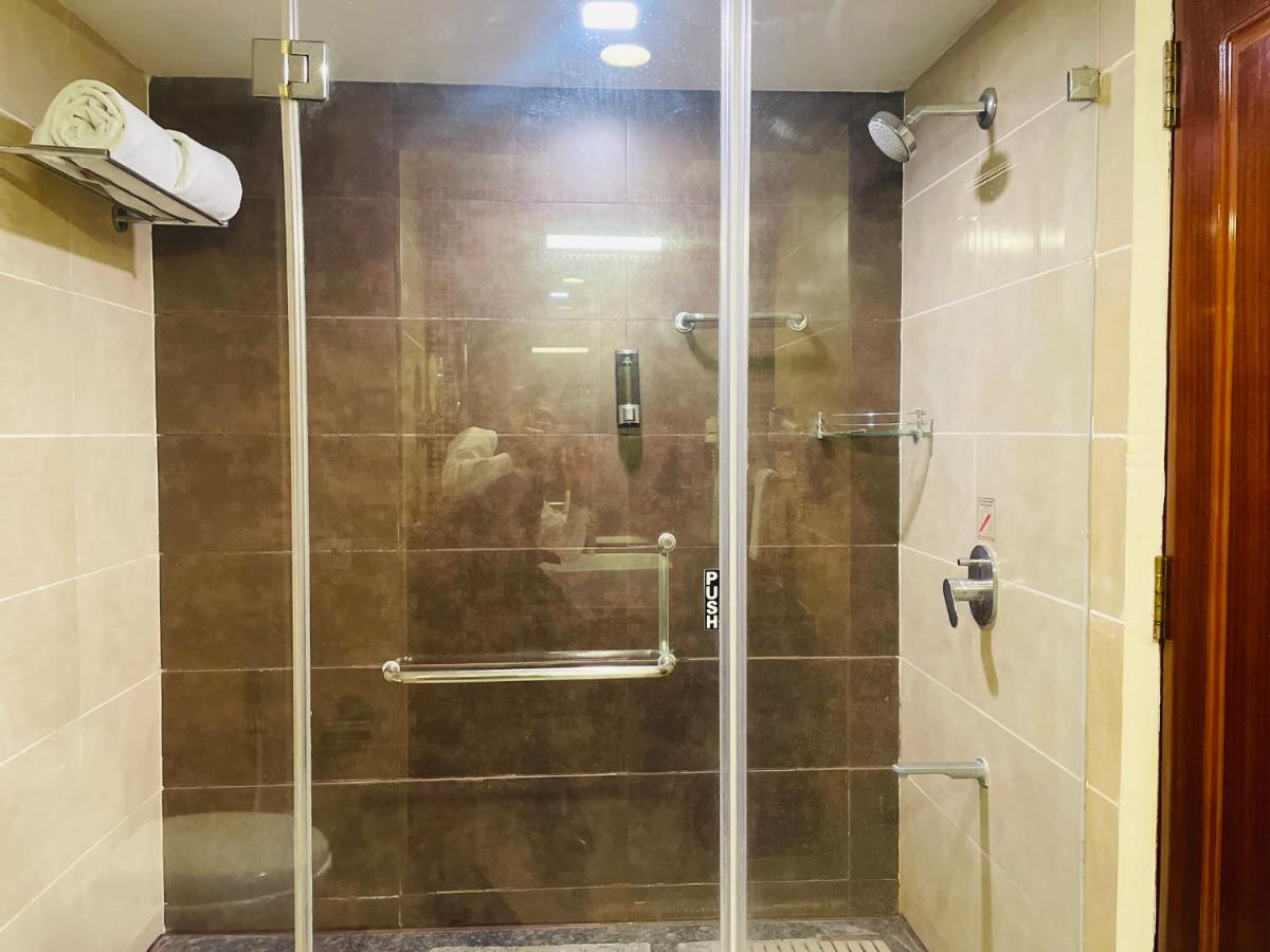 a shower with a glass door in a bathroom at Fortune JP Palace, Mysore - Member ITC Hotels' Group in Mysore