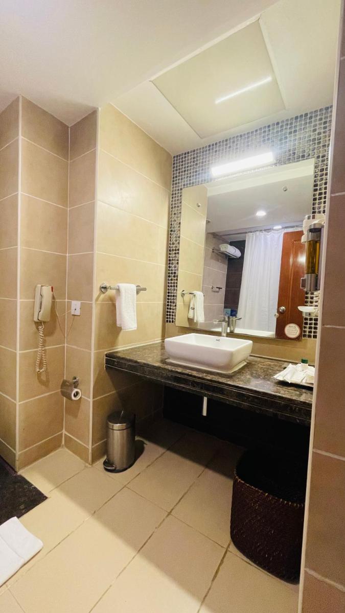 a bathroom with a sink and a mirror at Fortune JP Palace, Mysore - Member ITC Hotels' Group in Mysore