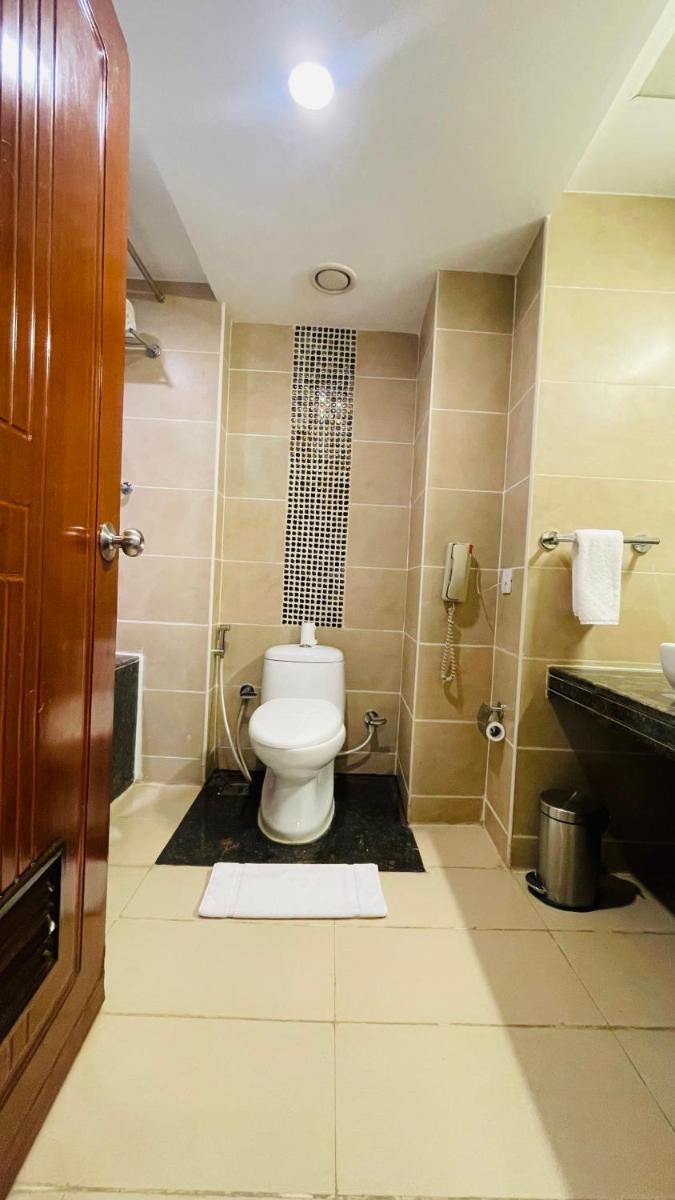 a bathroom with a toilet and a sink at Fortune JP Palace, Mysore - Member ITC Hotels' Group in Mysore