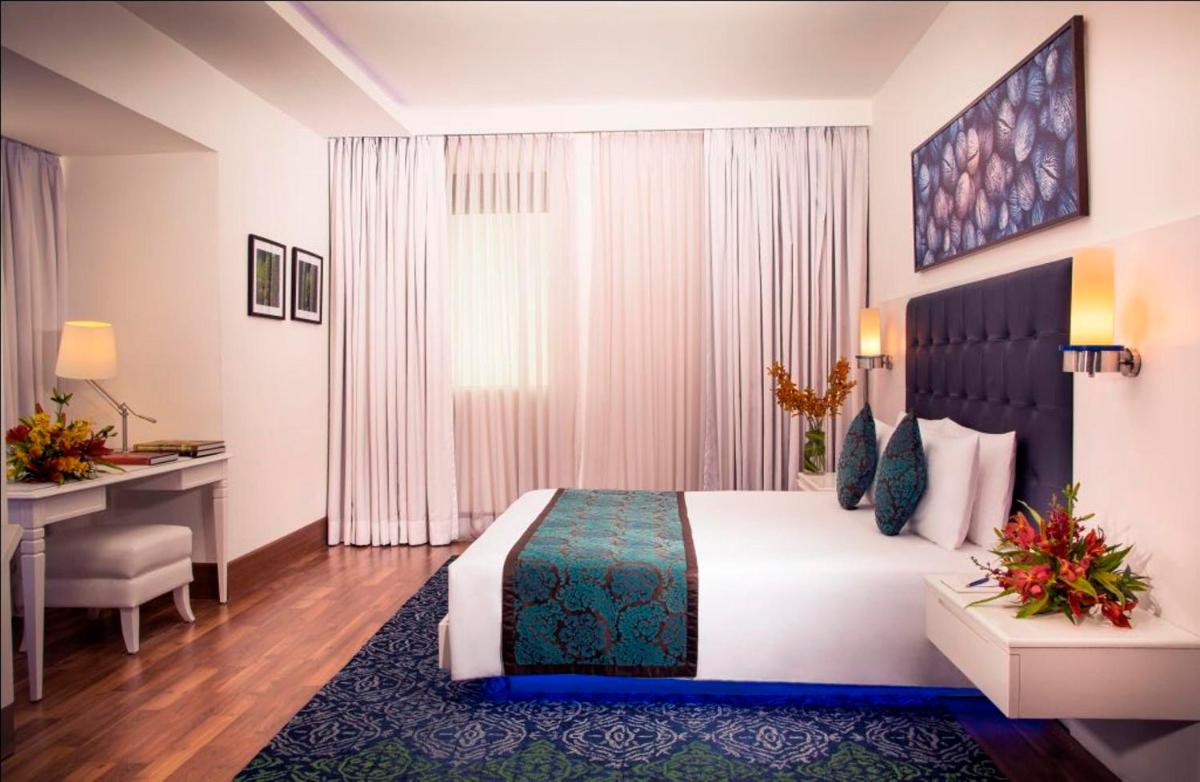 a hotel room with a bed and a desk at Radisson Blu Kochi in Cochin