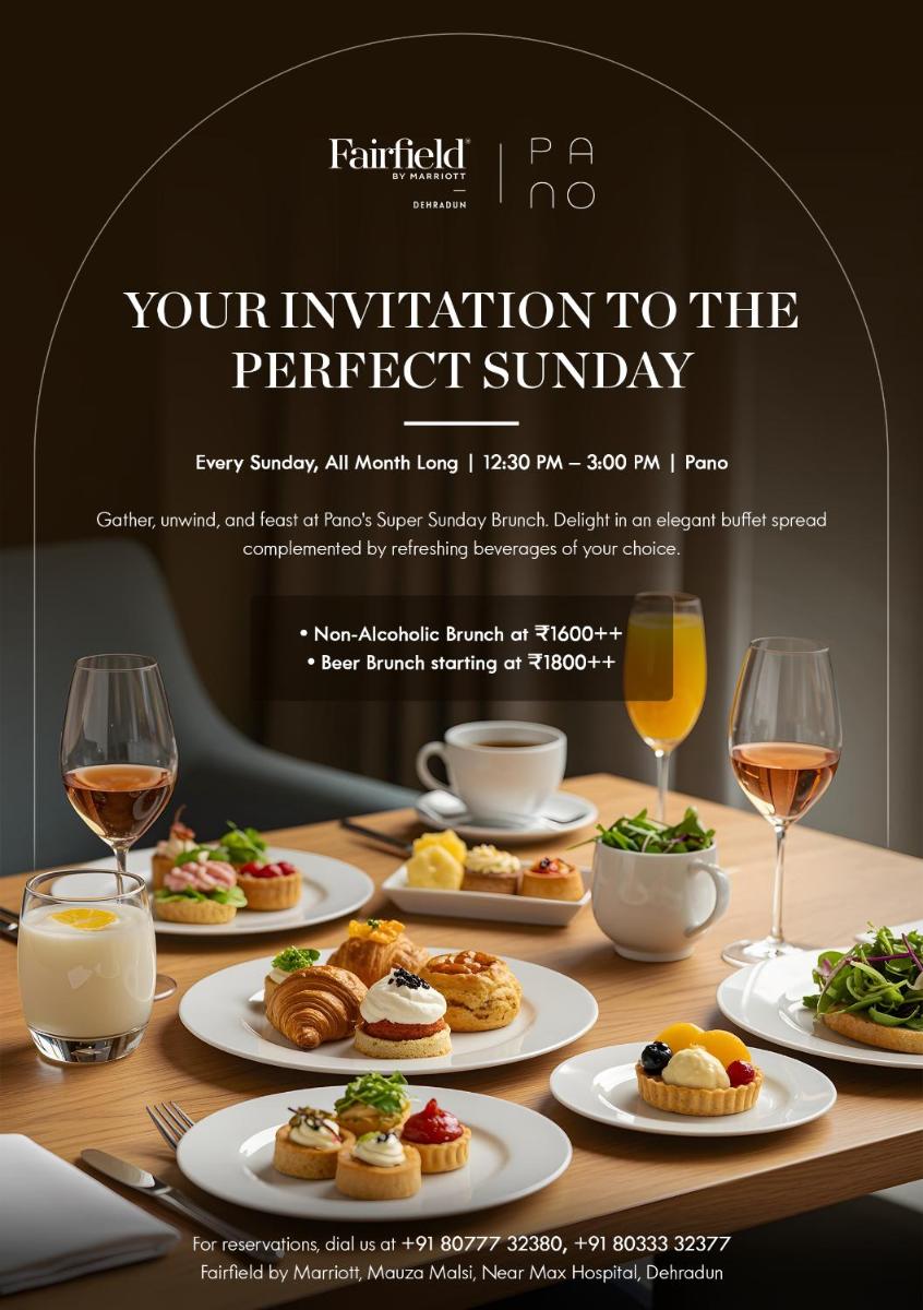 a table with plates of food and glasses of wine at Fairfield by Marriott Dehradun in Dehradun