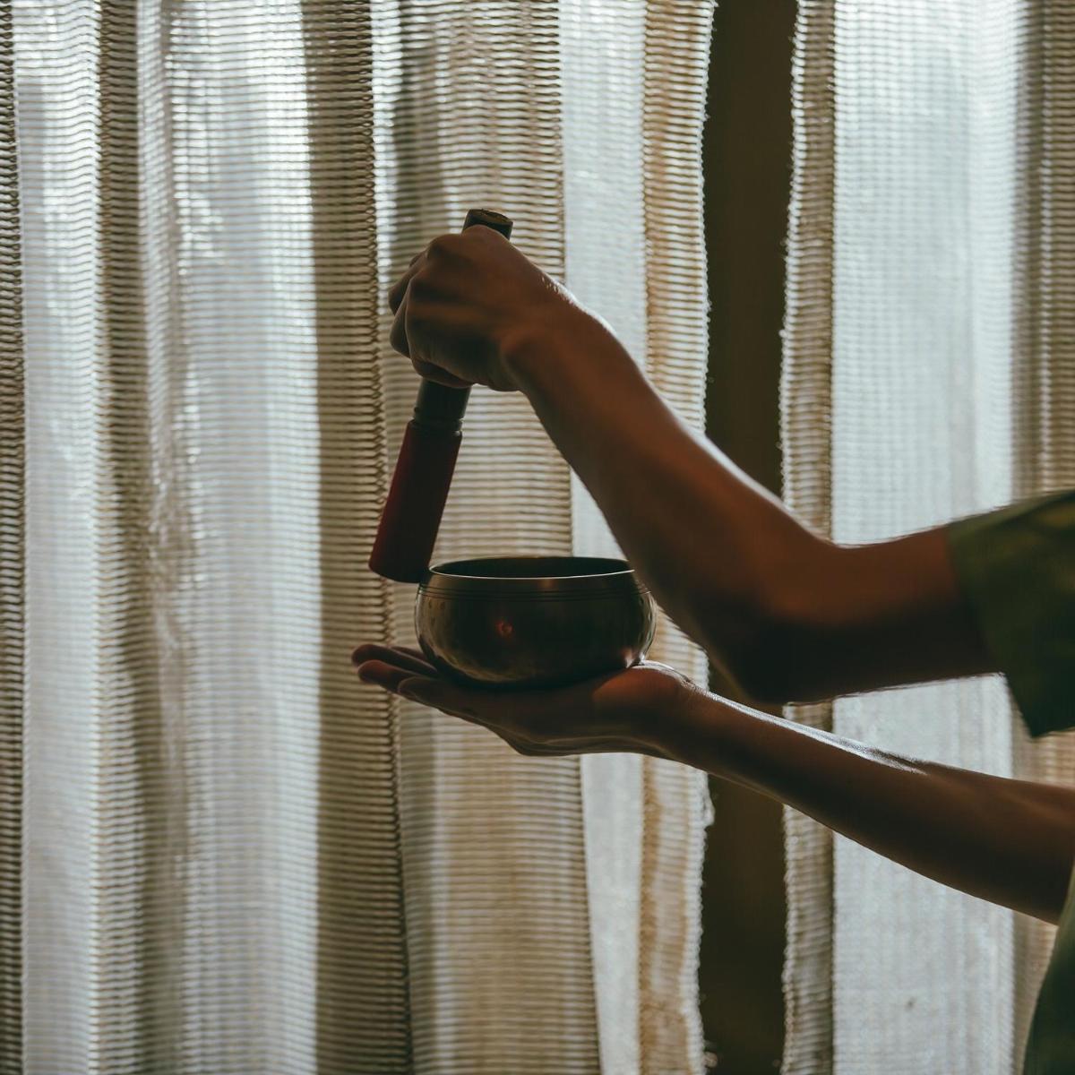 a person holding a cup in front of a window at Hyatt Regency Jaipur Mansarovar in Jaipur a person holding a cup in front of a window at Hyatt Regency Jaipur Mansarovar in Jaipur