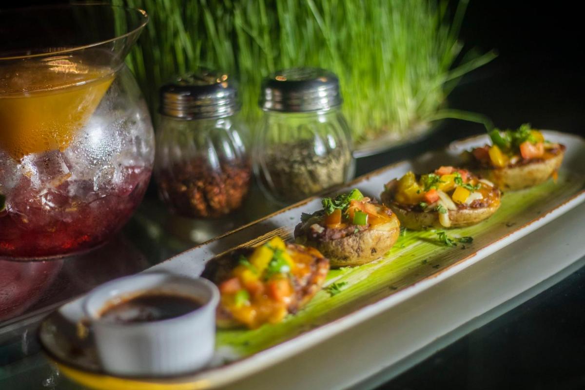 a plate of food with appetizers on a table at Holiday Inn Jaipur City Centre by IHG in Jaipur a plate of food with appetizers on a table at Holiday Inn Jaipur City Centre by IHG in Jaipur