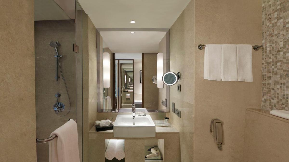 a bathroom with a sink and a mirror at Holiday Inn Jaipur City Centre by IHG in Jaipur a bathroom with a sink and a mirror at Holiday Inn Jaipur City Centre by IHG in Jaipur