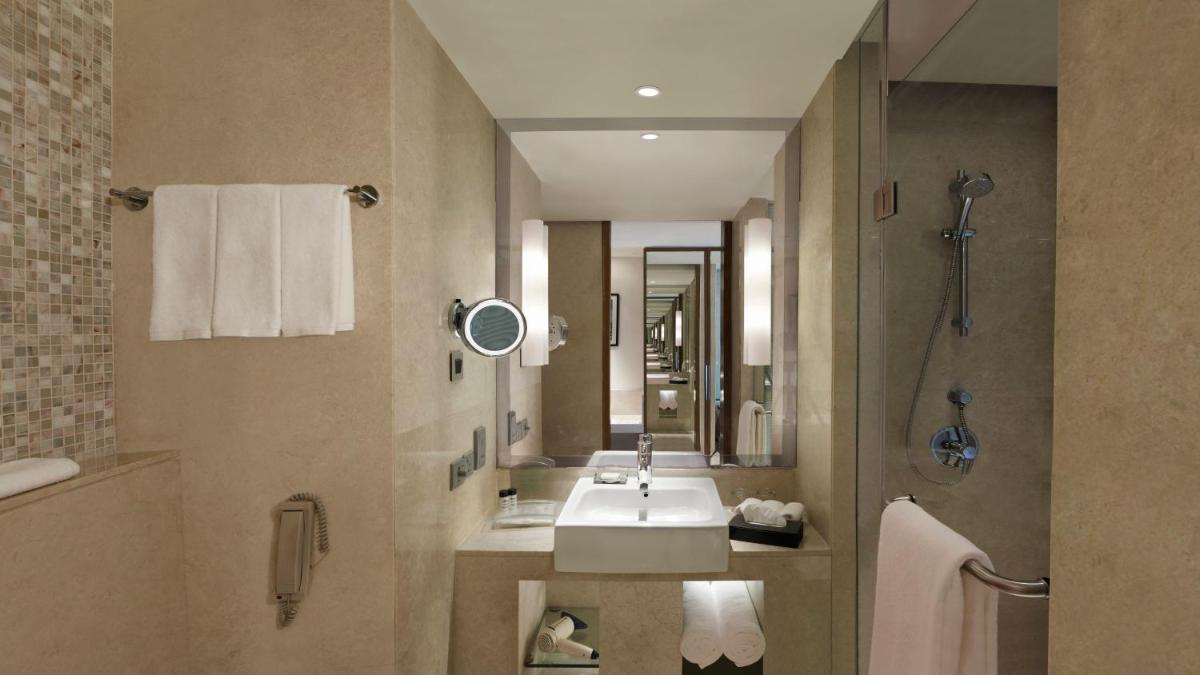 a bathroom with a sink and a mirror at Holiday Inn Jaipur City Centre by IHG in Jaipur a bathroom with a sink and a mirror at Holiday Inn Jaipur City Centre by IHG in Jaipur