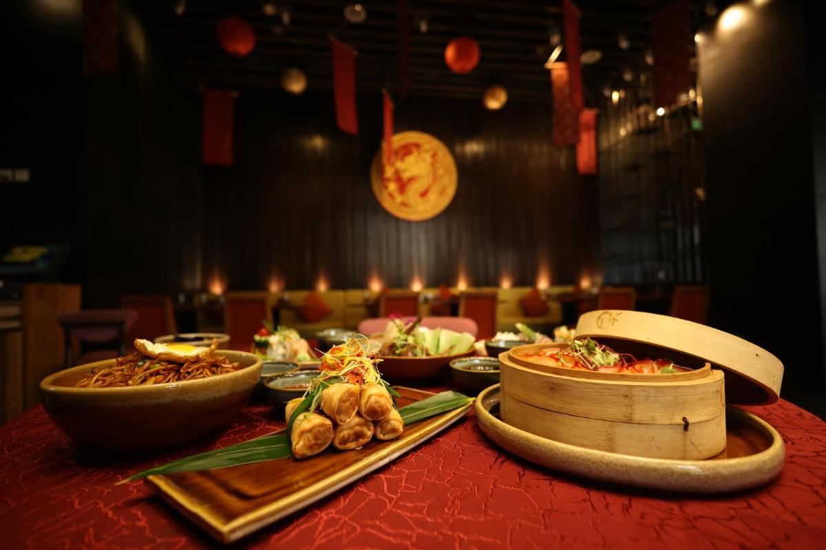 a table with plates of food on a table at Holiday Inn Jaipur City Centre by IHG in Jaipur a table with plates of food on a table at Holiday Inn Jaipur City Centre by IHG in Jaipur