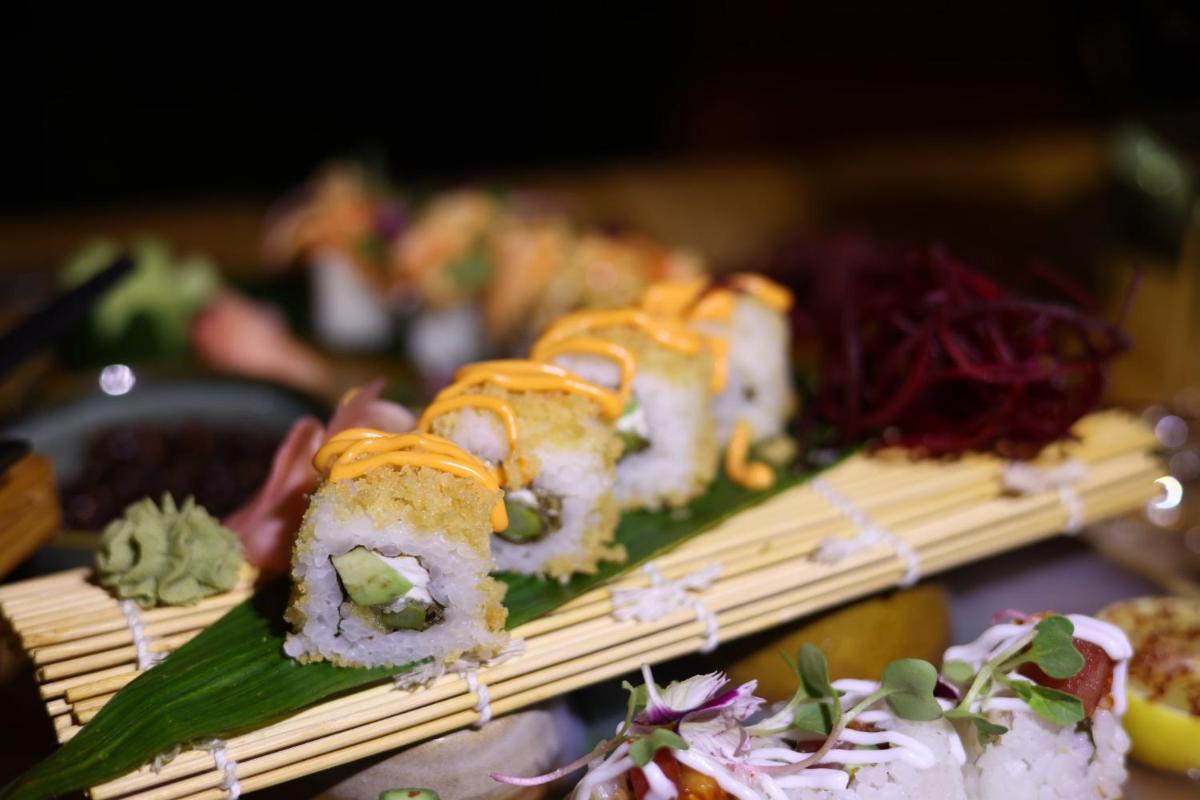 a group of sushi on bamboo skewers on a table at Holiday Inn Jaipur City Centre by IHG in Jaipur a group of sushi on bamboo skewers on a table at Holiday Inn Jaipur City Centre by IHG in Jaipur