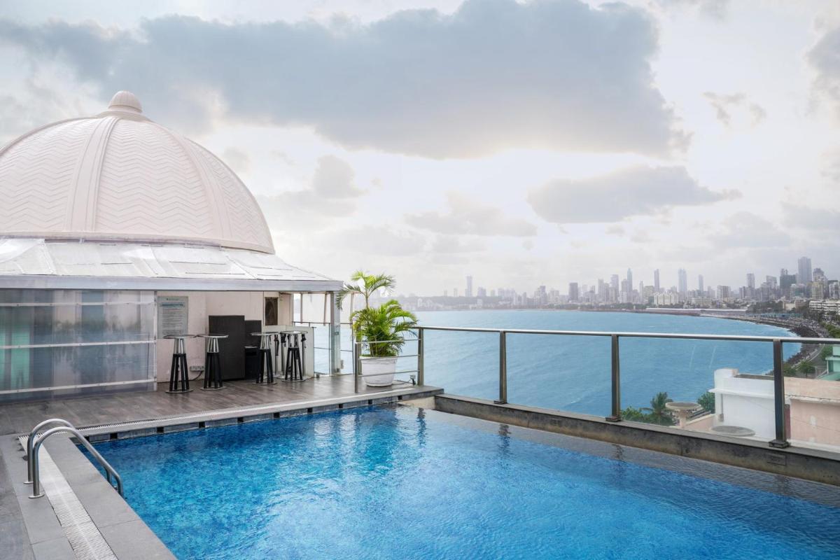 a pool on top of a building with a view of the city at InterContinental Marine Drive Mumbai by IHG in Mumbai