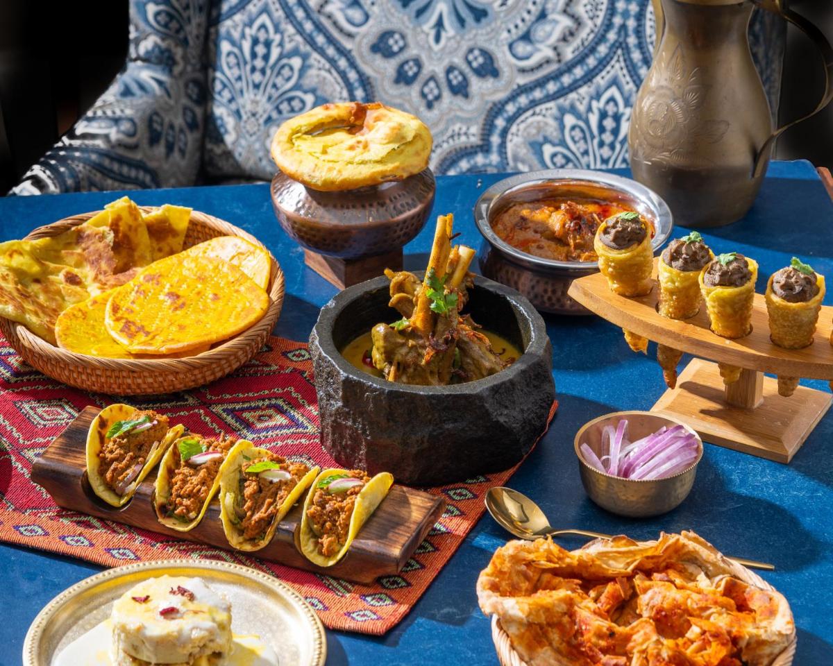 a table topped with lots of different types of food at InterContinental Marine Drive Mumbai by IHG in Mumbai