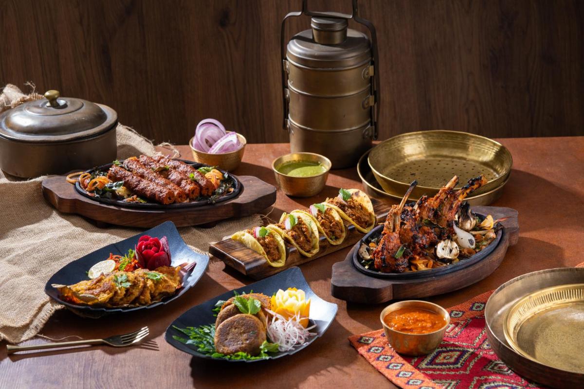 a table with many plates of food on it at InterContinental Marine Drive Mumbai by IHG in Mumbai