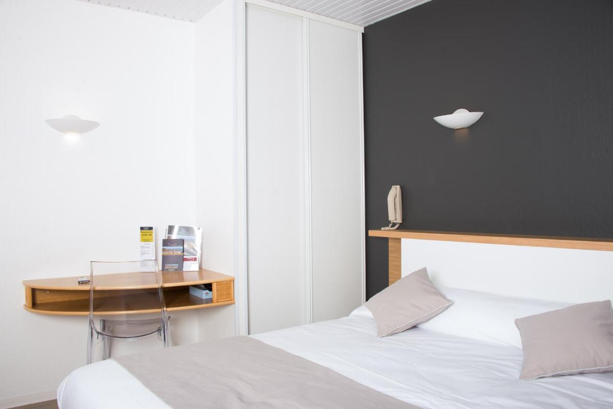 Un ou plusieurs lits dans un hébergement de l'établissement Hotel Les Dunes