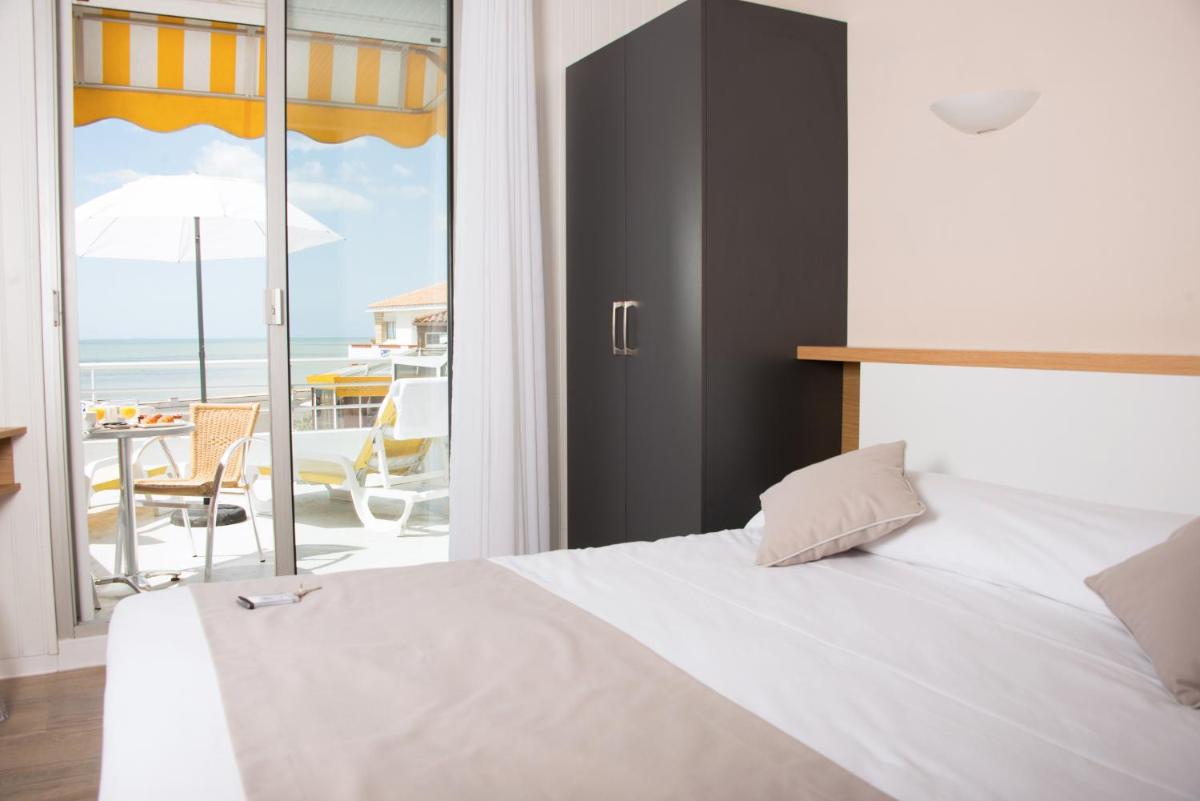 Un ou plusieurs lits dans un hébergement de l'établissement Hotel Les Dunes