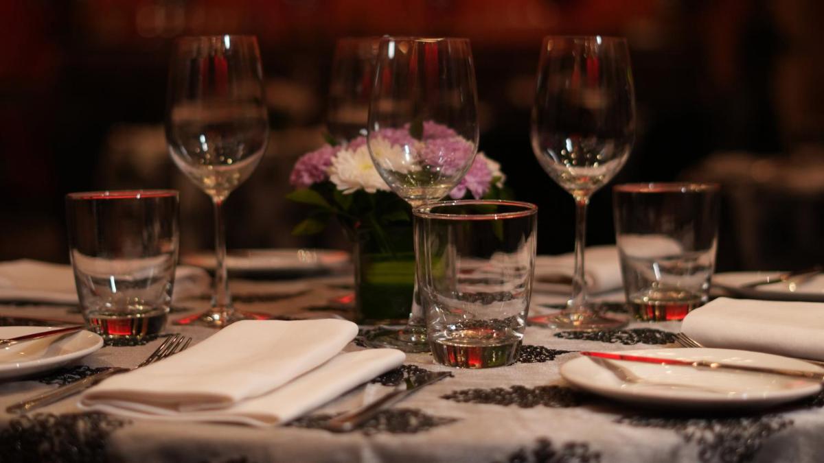 a table with wine glasses and napkins and flowers at InterContinental Marine Drive Mumbai by IHG in Mumbai