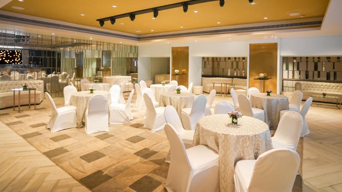 a banquet hall with white tables and white chairs at InterContinental Marine Drive Mumbai by IHG in Mumbai