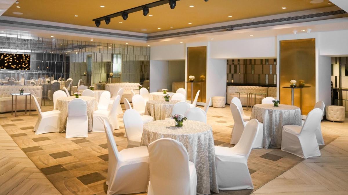 a banquet hall with white tables and white chairs at InterContinental Marine Drive Mumbai by IHG in Mumbai