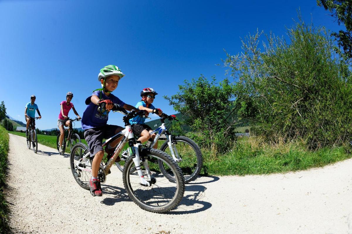 - un groupe d'enfants à vélo sur un chemin de terre dans l'établissement Joy Villard de Lans, à Villard-de-Lans