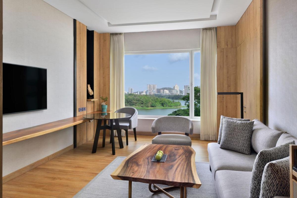 a living room with a couch and a table at The Westin Mumbai Powai Lake in Mumbai