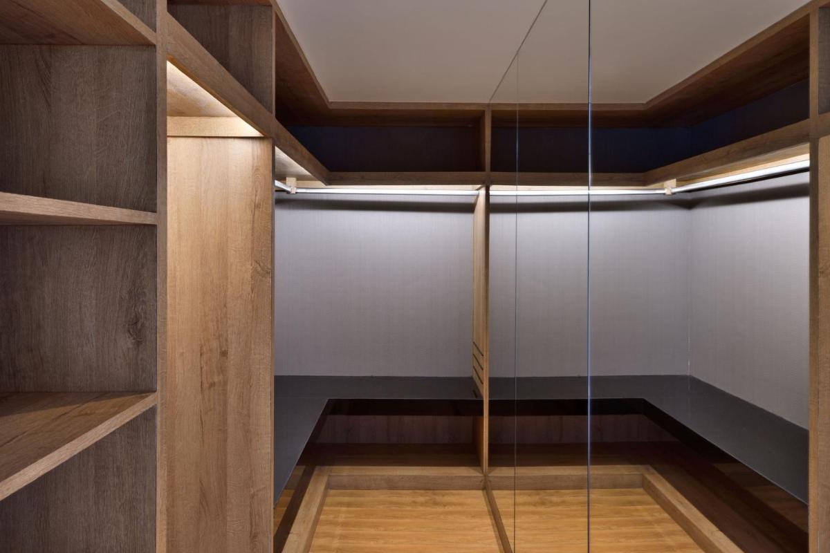 a room with glass doors and a ceiling at The Westin Mumbai Powai Lake in Mumbai