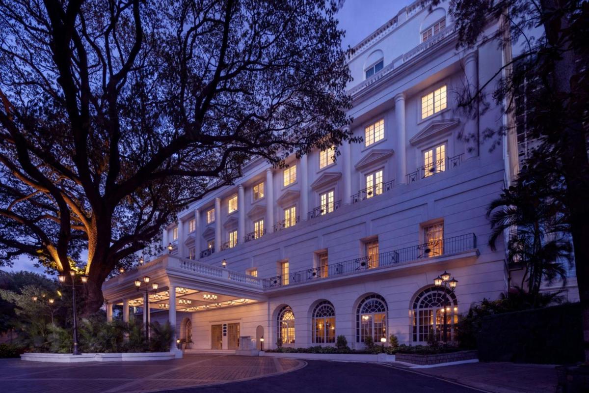 a large white building with lights on at ITC Windsor, a Luxury Collection Hotel, Bengaluru in Bengaluru a large white building with lights on at ITC Windsor, a Luxury Collection Hotel, Bengaluru in Bengaluru