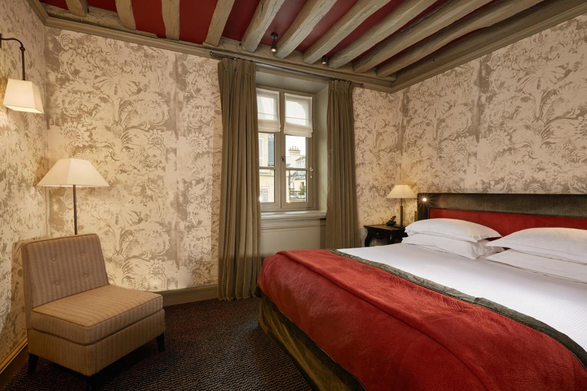 Un ou plusieurs lits dans un hébergement de l'établissement Le Pavillon de la Reine & Spa, Place des Vosges
