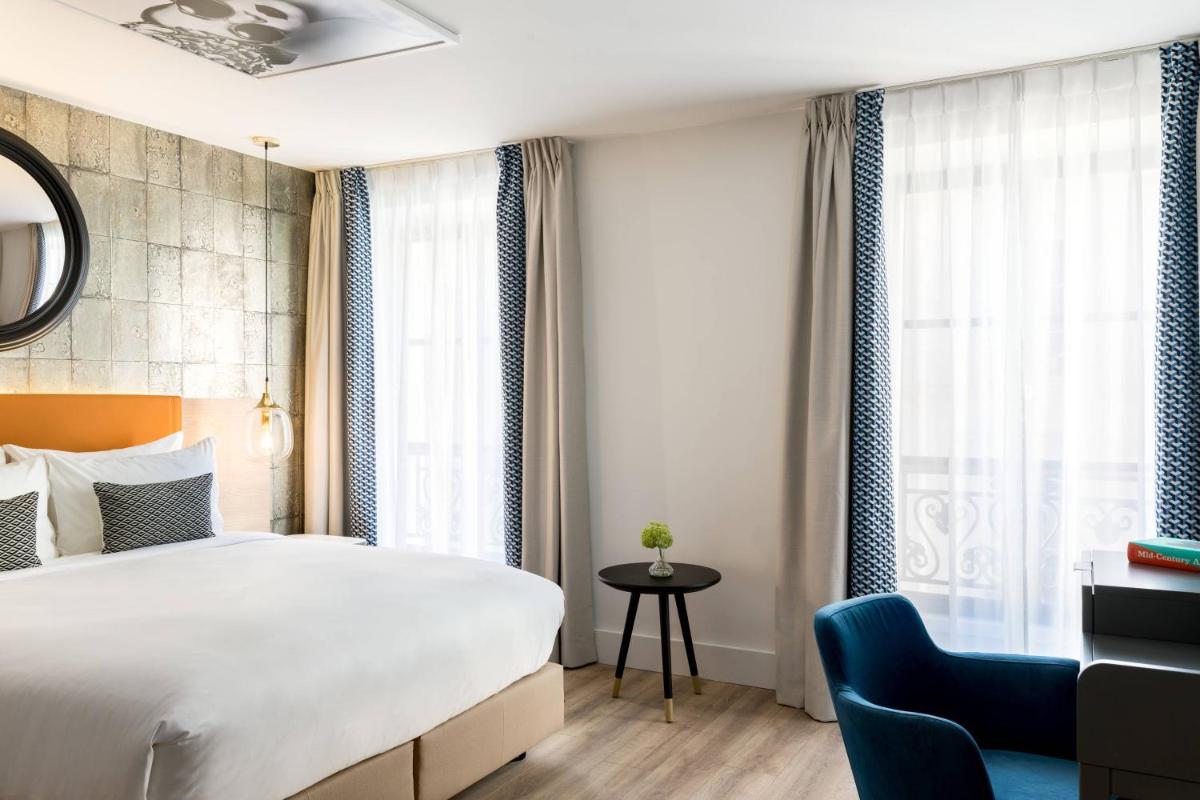 Un ou plusieurs lits dans un hébergement de l'établissement Renaissance Paris Vendome Hotel
